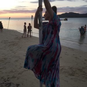 Bonnie Gillespie starts a pole trick in Fiji while others get selfies with the sunset, Feb. 2020