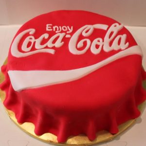 Coca-Cola bottle-top-shaped frosting on a cake