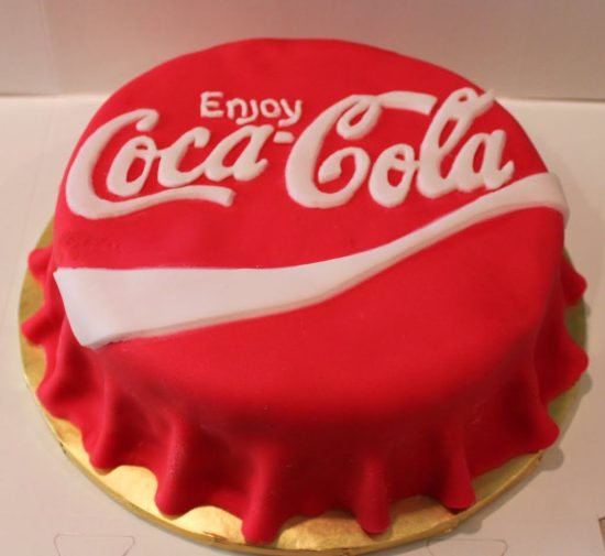 Coca-Cola bottle-top-shaped frosting on a cake