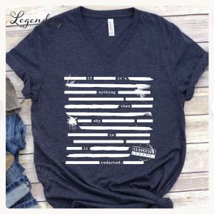 flat lay of navy blue T-shirt with white text peeking from lines covering redacted sections: If it's nothing then why is it redacted?